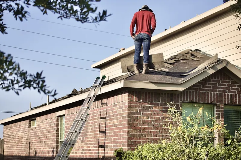 Professional roofer working on a residential roof in North Davis Shores